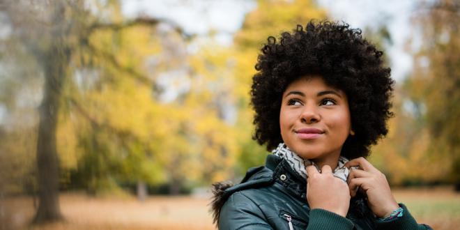 Candid shot of a young woman outdoors in autumn.