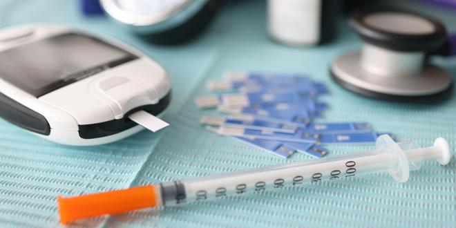 a diabetes testing strip and syringe