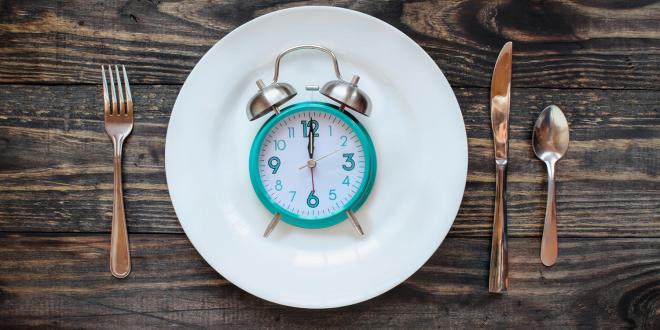 a clock on a dinner plate