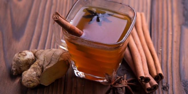 a mug of apple cranberry cider with cinnamon, star anise, and ginger