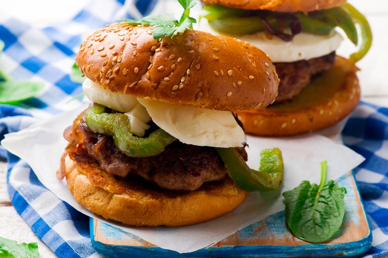 A plate of chicken sausage sliders with bell peppers and fresh basil