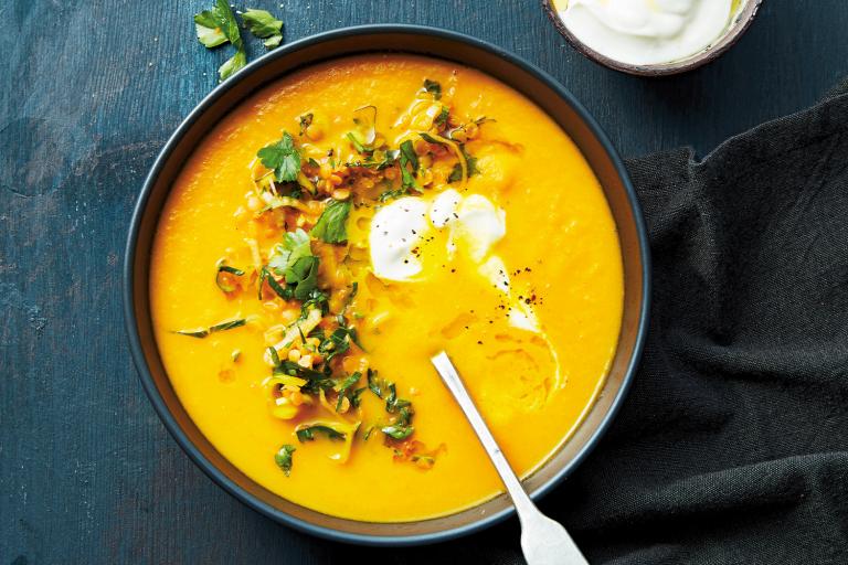 a garnished bowl of carrot soup